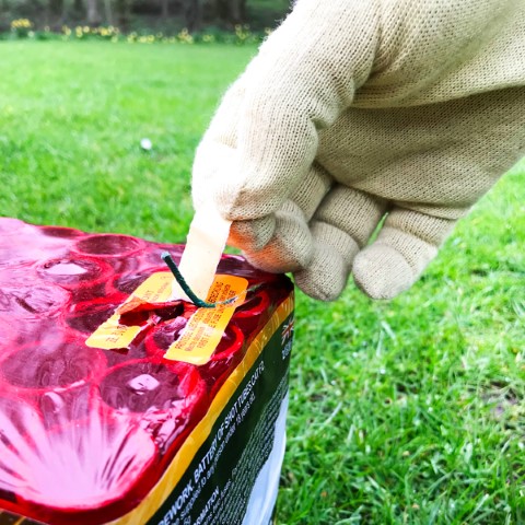 Remove the orange fuse cover and if required pull fuse through clear plastic on top of the cake for easier access.